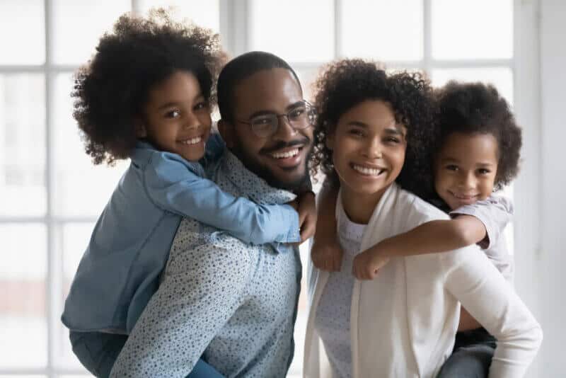 african american family with two children smiling