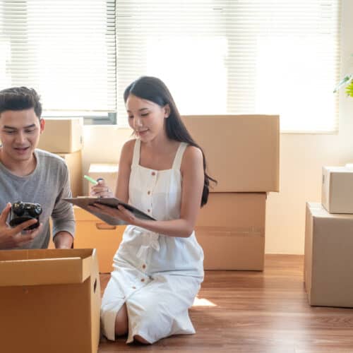 young couple going through boxes in their house