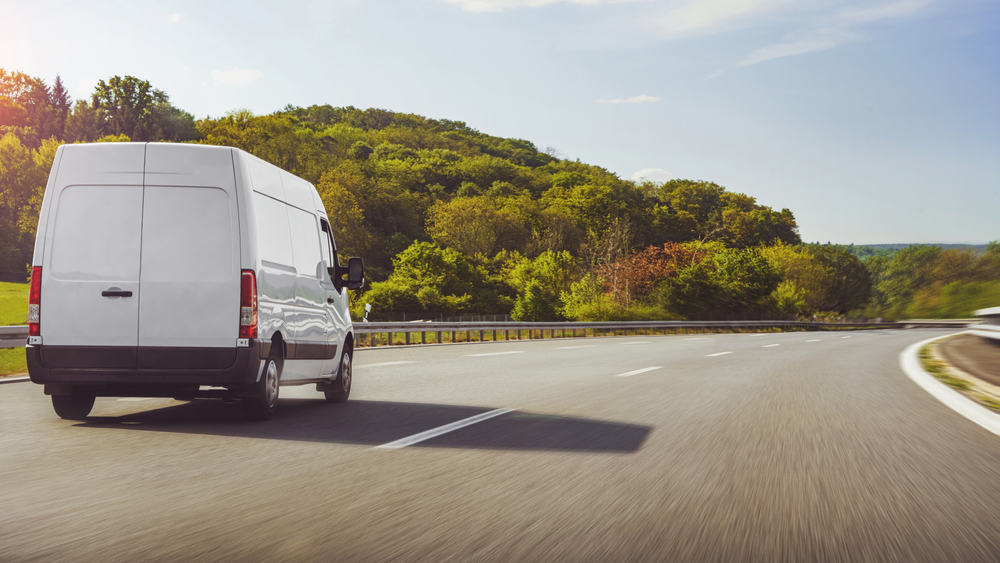 commercial delivery van driving down highway