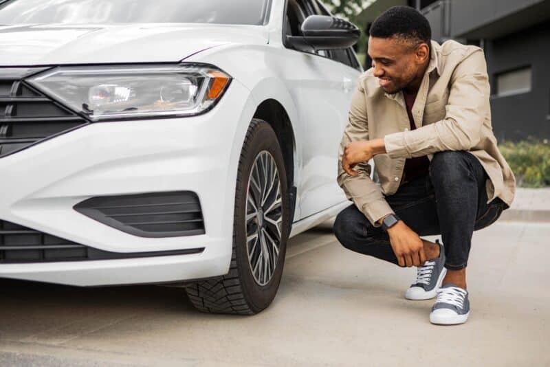 African American man checks his tires