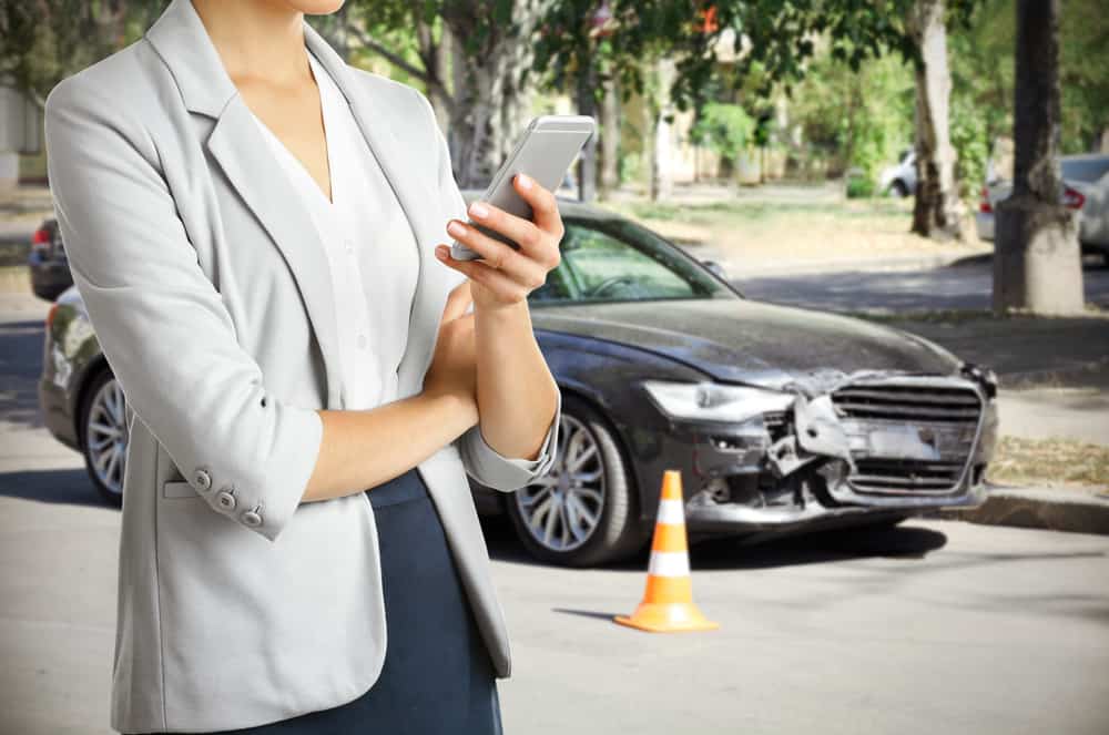 A lady calls her car insurance company after someone ran into her car in a hit and run