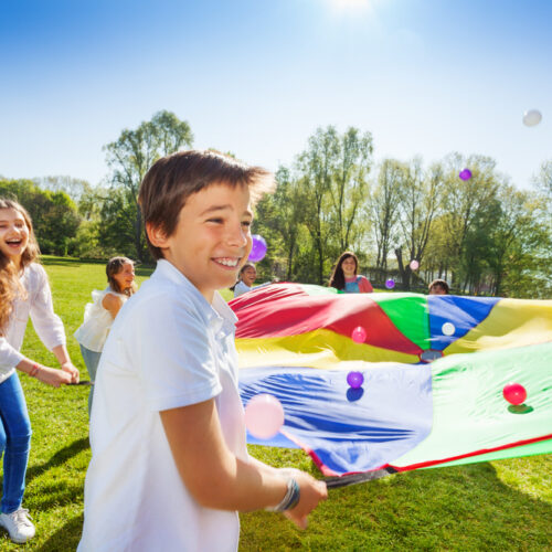 Kids playing bounce the balls at summer camp