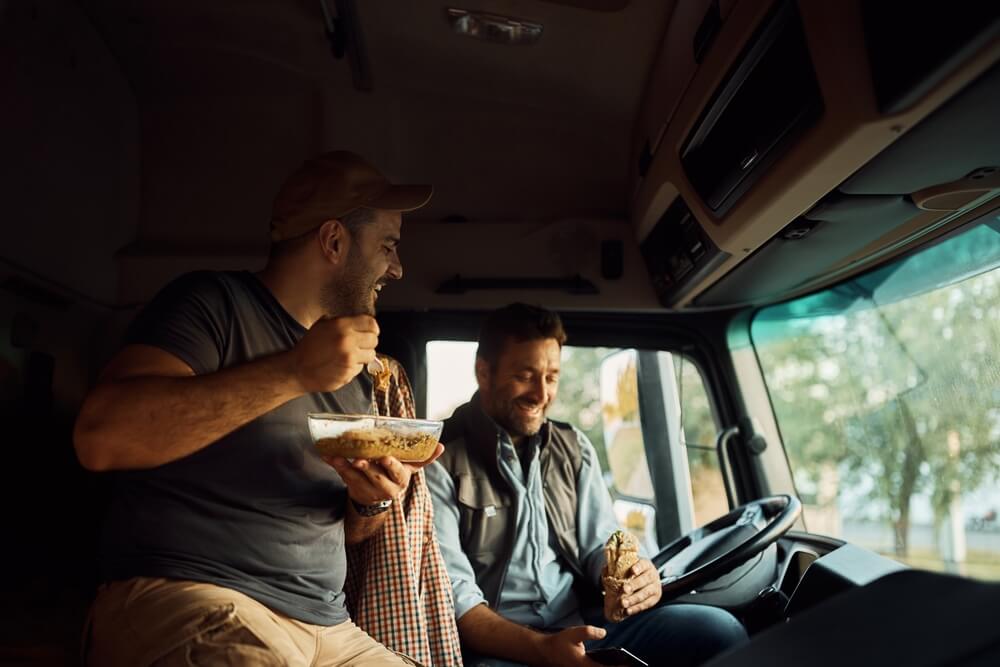 Truck drivers eating and having fun for being protected with commercial car insurance - Cheap car insurance in Washington