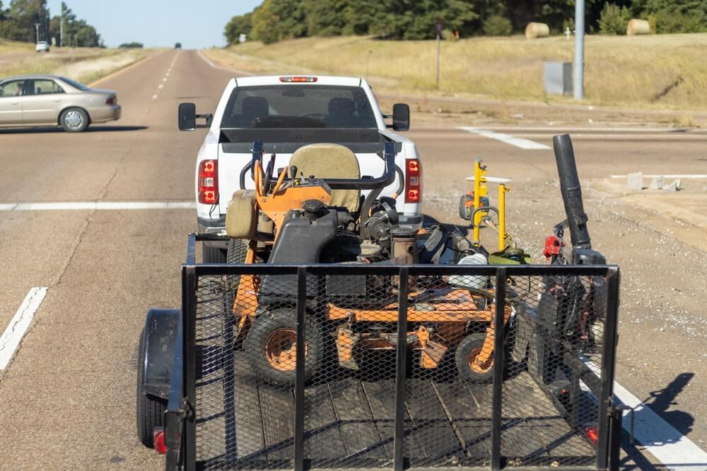 Pickup truck hauling a trailer with landscaping equipment in it - cheap insurance in Washington.