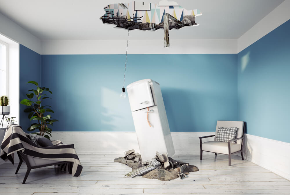 Refrigerator falls from the ceiling next to a sofa and a light bulb.