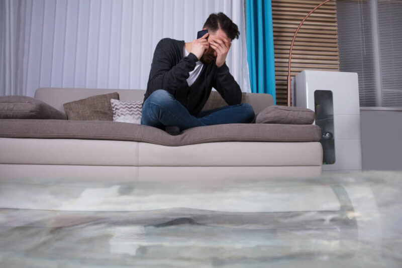 Man watching how his house is being flooded